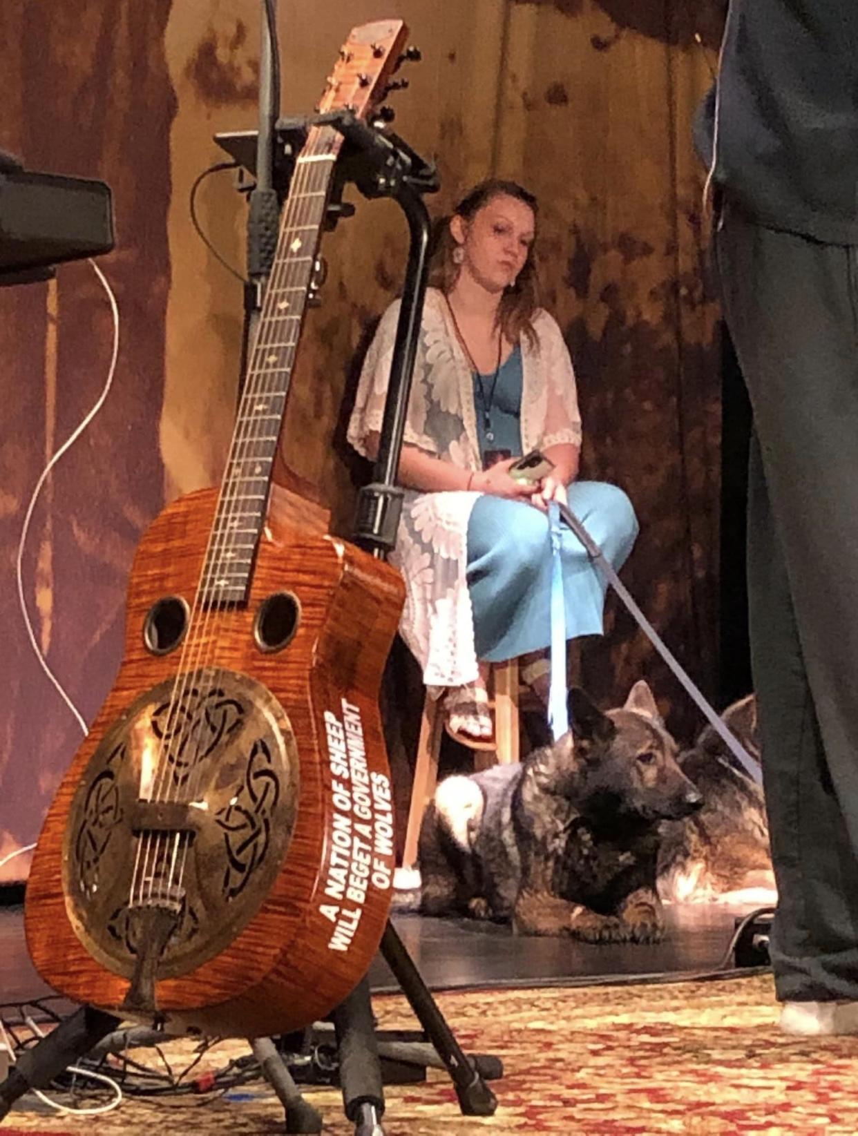 Oliver Anthony's American-made guitar, dog handler and dog Sasha on the Beacon Theatre stage on Easter 2024.