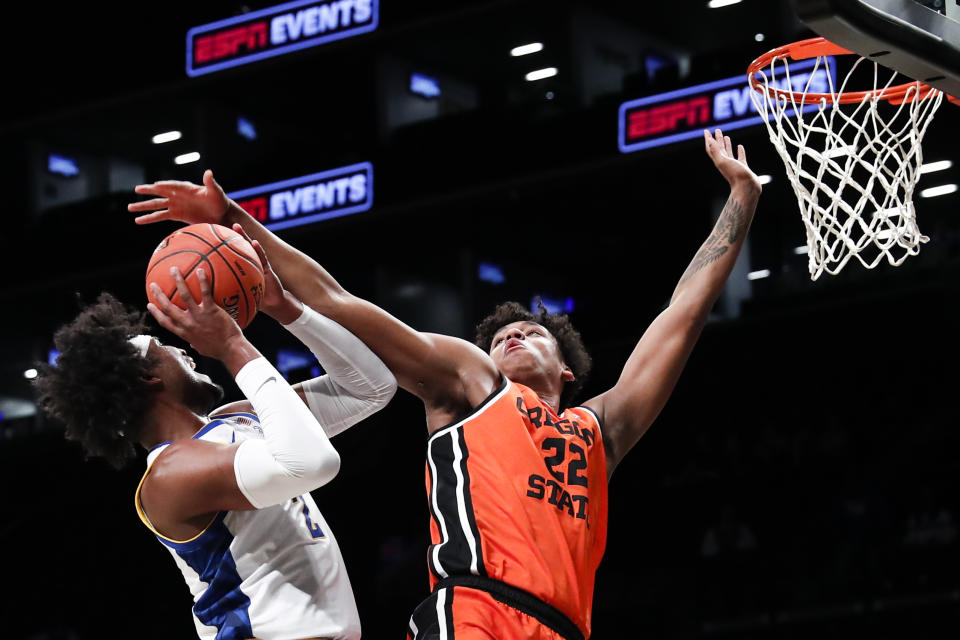 Oregon St forward Thomas Ndong (22) defends against Pittsburgh forward Blake Hinson (2) during the first half of an NCAA college basketball game in the NIT Season Tip-Off, Friday, Nov. 24, 2023, in New York. (AP Photo/Eduardo Munoz Alvarez)