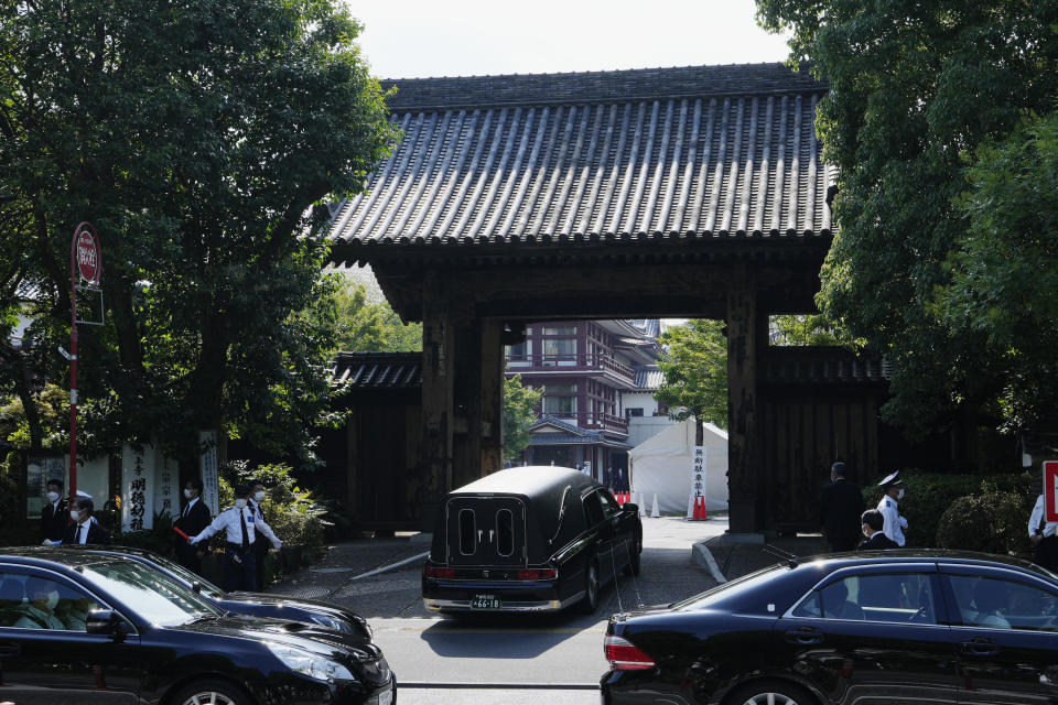 The hearse carrying the body of former Japanese Prime Minister Shinzo Abe gets into Zojoji temple for the funeral wake in Tokyo on Monday, July 11, 2022. (AP Photo/Hiro Komae)