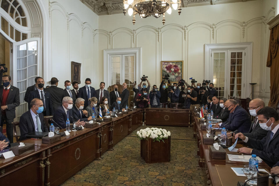 Israeli Foreign Minister Yair Lapid, center left, meets with Egyptian Foreign Minister Sameh Shoukry at Tahrir Palace in Cairo, Egypt, Thursday, Dec. 9, 2021. (AP Photo/Nariman El-Mofty)