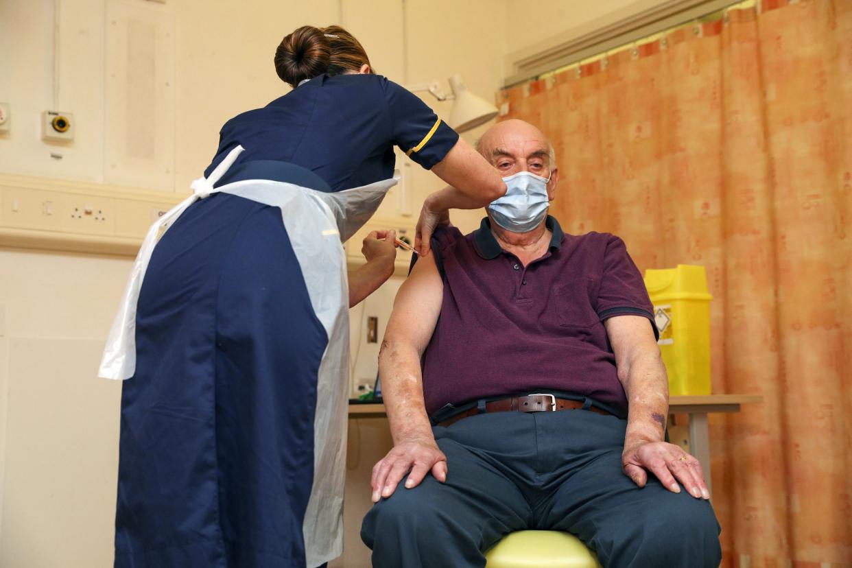 82-year-old Brian Pinker receives the Oxford University/AstraZeneca COVID-19 vaccine from nurse Sam Foster at the Churchill Hospital in Oxford, England on Monday, Jan. 4, 2021. Pinker, a retired maintenance manager received the first injection of the new vaccine developed by Oxford University and drug giant AstraZeneca.