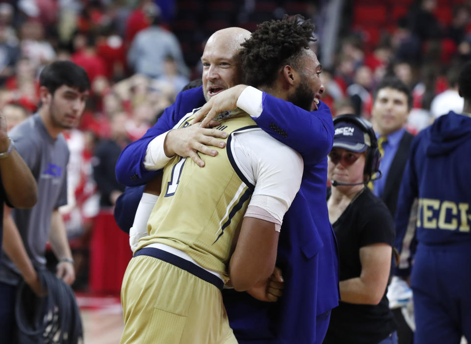 Georgia Tech assistant coach Julian Swartz hugs James Banks III (1) after Georgia Tech's 82-81 overtime victory over North Carolina State in an NCAA college basketball game Tuesday, Nov. 5, 2019, in Raleigh, N.C. (Ethan Hyman/The News & Observer via AP)