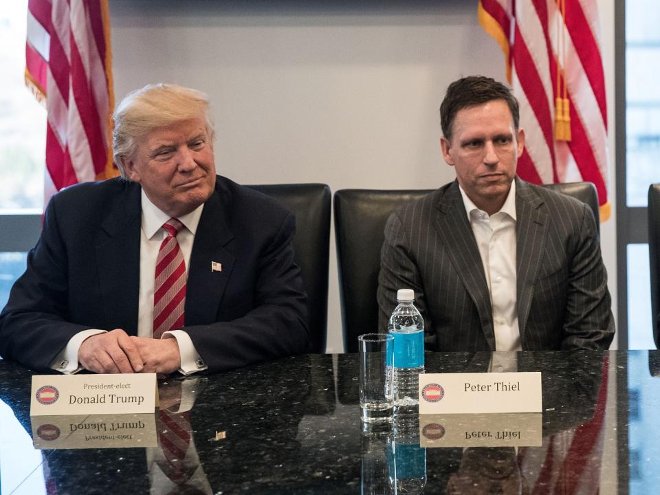 Donald Trump and Peter Thiel sitting at a conference table.