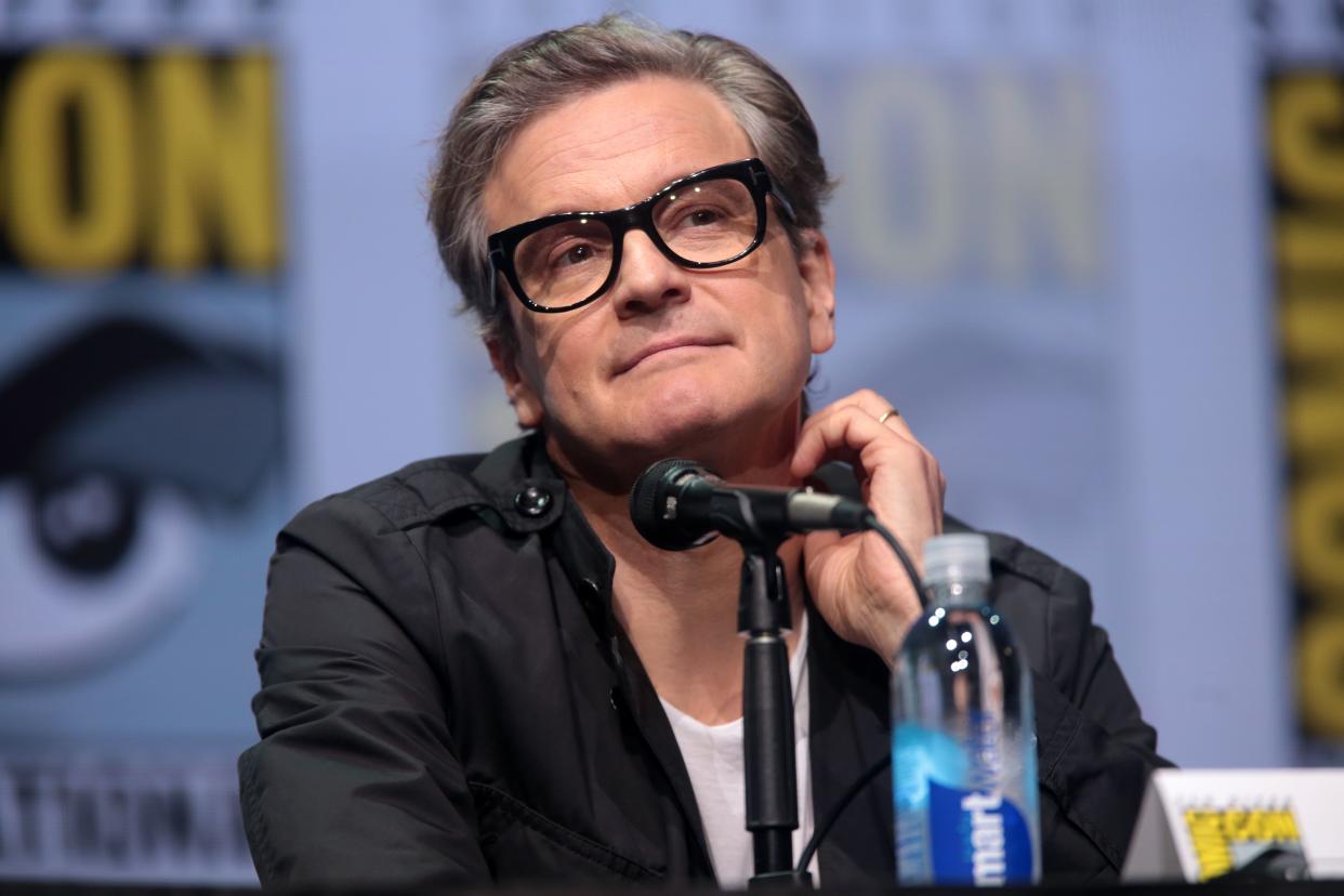 Colin Firth sports a black T-shirt with white inner-wear and a pair of glasses