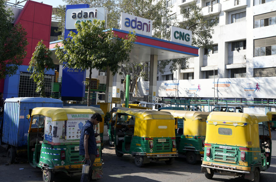 Autorickshaws wait at an Adani Compressed Natural Gas (CNG) station in Ahmedabad, India, Feb. 2, 2023. India's Gautam Adani was Asia's richest man when the U.S. short-selling firm Hindenburg Research put out a report last week alleging his businesses have engaged in fraud and stock price manipulation. The allegations spooked investors, who dumped tens of billions of dollars worth of shares, leading Adani to call off a $2.5 billion share offering in his flagship company, Adani Enterprises. (AP Photo/Ajit Solanki)
