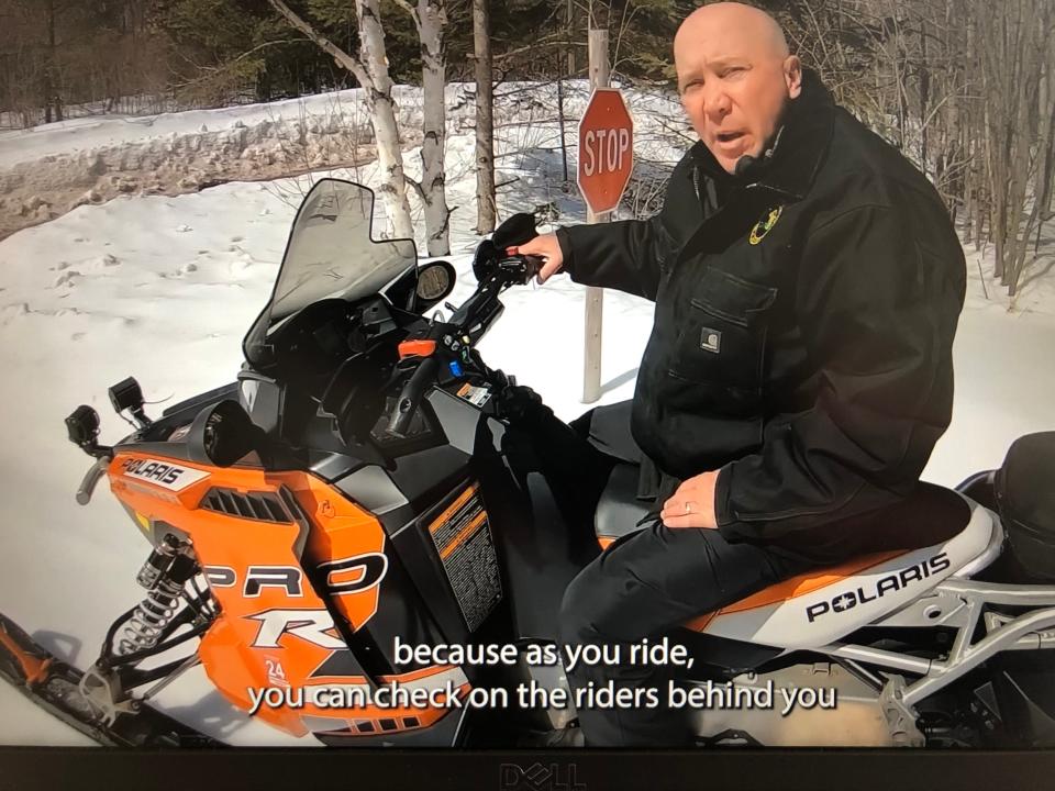 Taking his helmet off to talk for a new 2024 video, Ron Yesney, Upper Peninsula trails coordinator for the Michigan Department of Natural Resources, explains how to "lead right" on a snowmobile.
