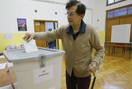 A woman casts her vote at a polling station during the presidential election in Vipavski Kriz, Slovenia October 22, 2017. REUTERS/Srdjan Zivulovic