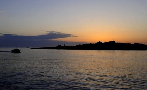 File photo shows a refugee boat entering the port of Lampedusa in April 2011. Italian coast guards found 25 dead bodies in the hold of a refugee boat with 271 people crammed on board that arrived on the southern island of Lampedusa on Monday, local port authorities said