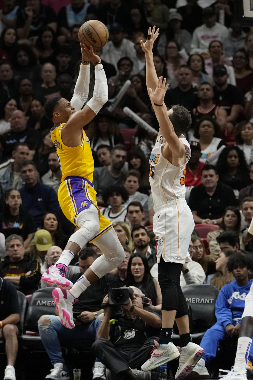 Los Angeles Lakers guard Russell Westbrook, left, shoots as Miami Heat forward Duncan Robinson defends during the first half of an NBA basketball game, Wednesday, Dec. 28, 2022, in Miami. (AP Photo/Lynne Sladky)