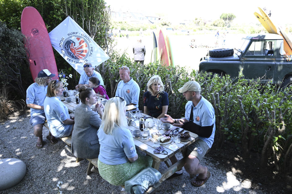 US First Lady Jill Biden, second right, meets military surfers and their families in Newlyn, Cornwall, England, on the sidelines of the G7 summit, Saturday June 12, 2021. US First Lady Jill Biden met with veterans, first responders and family members of Bude Surf Veterans, a Cornwall-based volunteer organization that provides social support and surfing excursions for veterans, first responders and their families. (Daniel Leal-Olivas/Pool via AP)