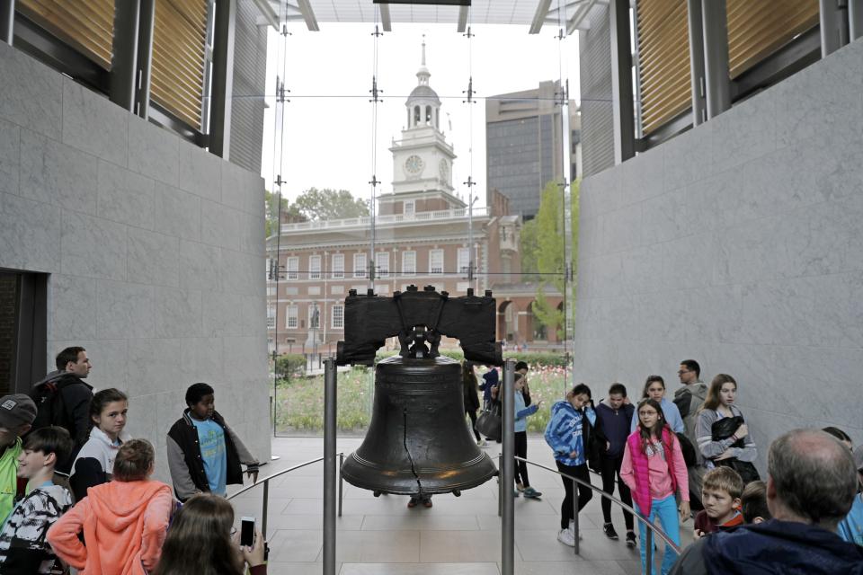 FILE - In this May 5, 2016, file photo, people file past the Liberty Bell in Independence Hall in Philadelphia. The coronavirus pandemic in 2020 not only upended the tourism industry, but how states, cities and attractions market themselves as summer travel destinations. (AP Photo/Matt Rourke, File)