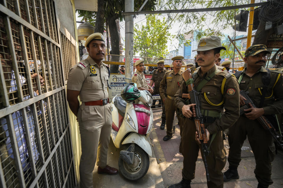 Police restrain opposition Congress party workers from coming out of the Assam Pradesh Congress party office to prevent them take out a protest against the Citizenship Amendment Act (CAA) in Guwahati, India, Tuesday, March 12, 2024. India has implemented a controversial citizenship law that has been widely criticized for excluding Muslims, a minority community whose concerns have heightened under Prime Minister Narendra Modi’s Hindu nationalist government. The act provides a fast track to naturalization for Hindus, Parsis, Sikhs, Buddhists, Jains and Christians who fled to Hindu-majority India from Afghanistan, Bangladesh and Pakistan before Dec. 31, 2014. (AP Photo/Anupam Nath)