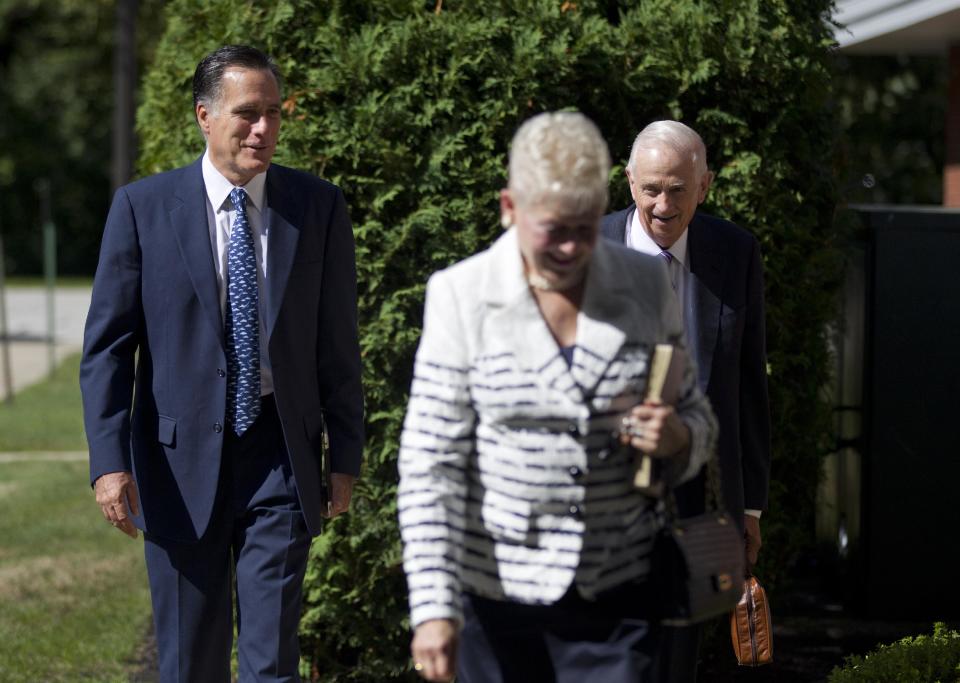 Republican presidential candidate, former Massachusetts Gov. Mitt Romney, left, walks towards the Church of Jesus Christ of Latter-day Saints on Sunday, Aug. 19, 2012 in Wolefboro, N.H. (AP Photo/Evan Vucci)