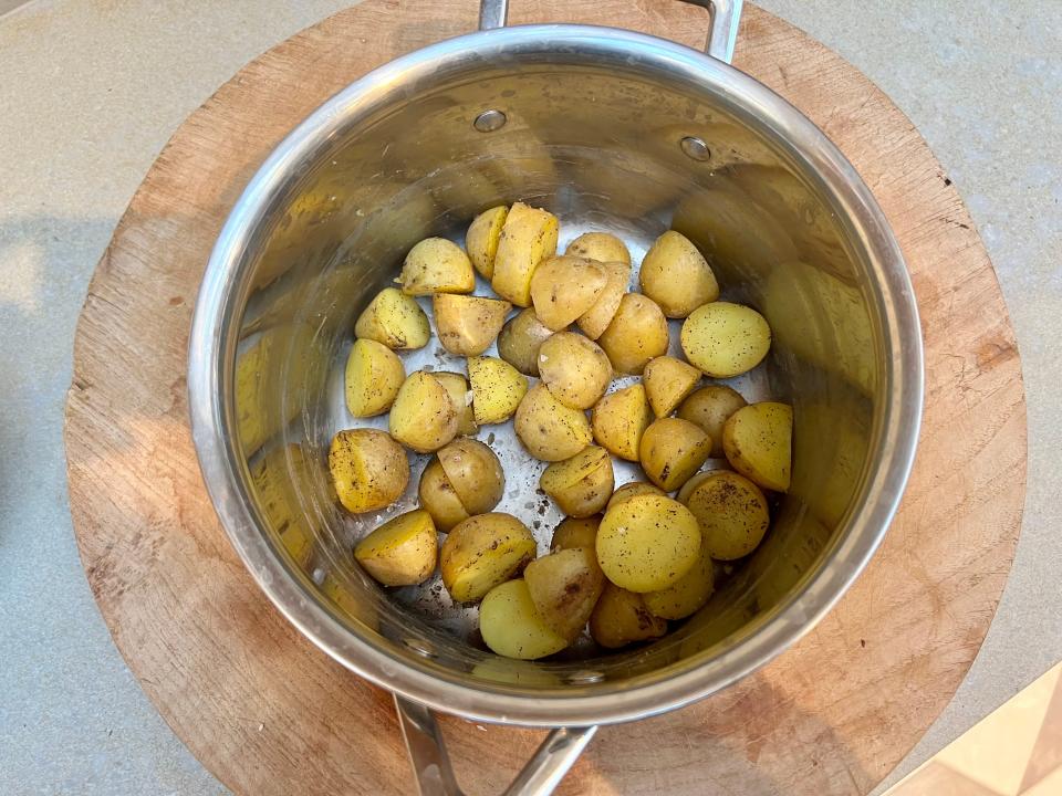 Seasoning the potatoes.