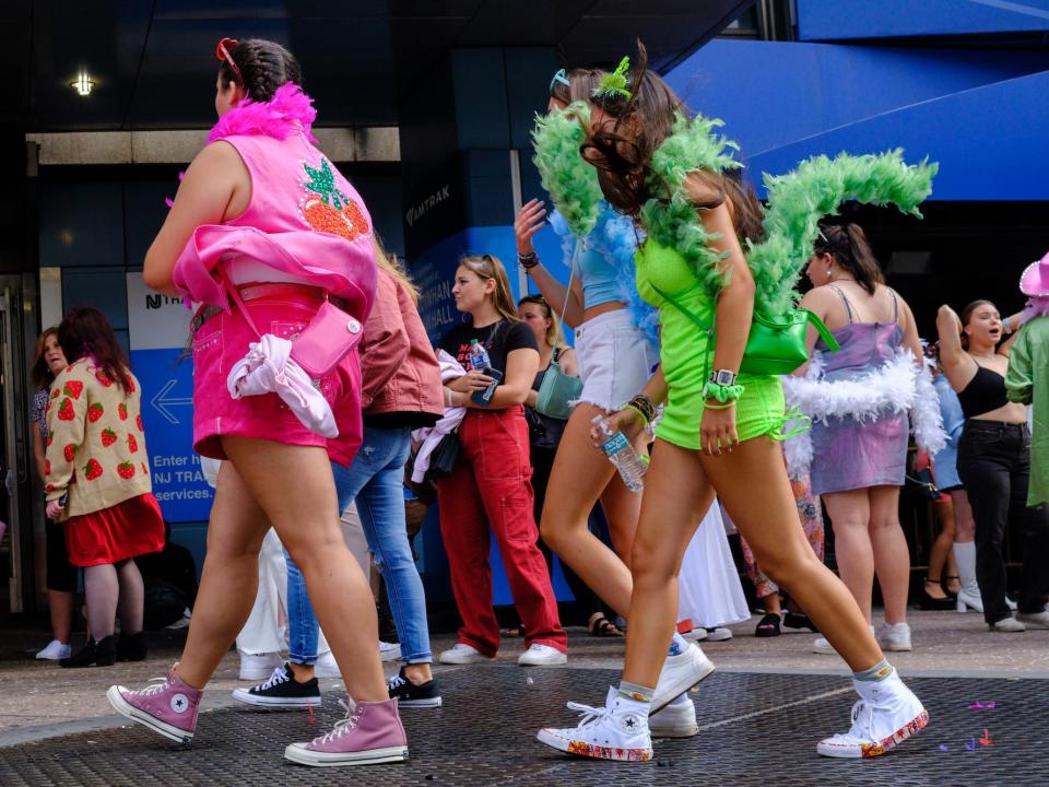 Fans of Harry Styles wear colorful outfits at the New York City stop of Love On Tour 2022.