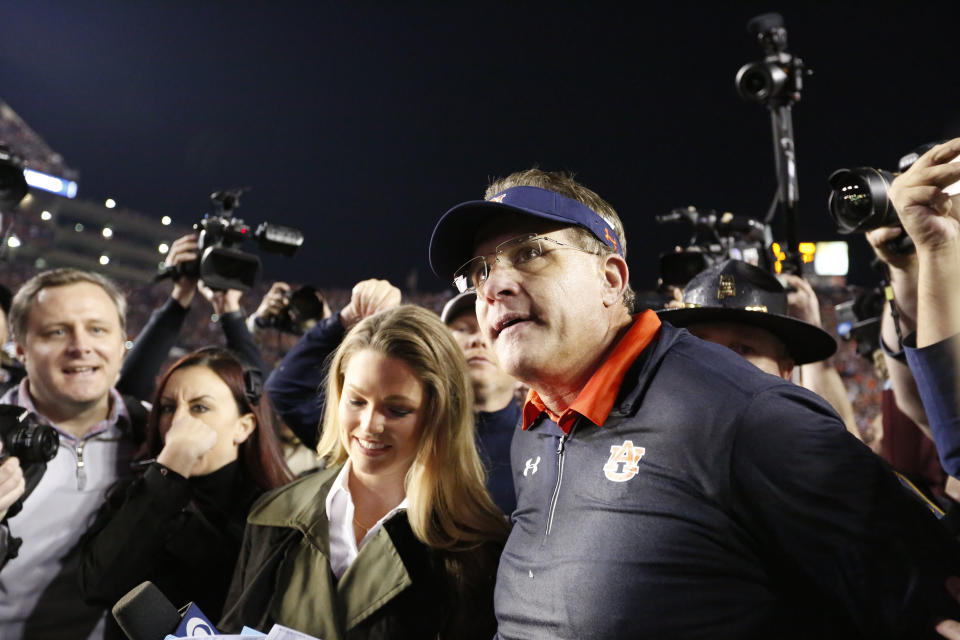 Auburn head coach Gus Malzahn on the field talks to the media after the Iron Bowl NCAA college football game, Saturday, Nov. 25, 2017, in Auburn, Ala. (AP Photo/Brynn Anderson)