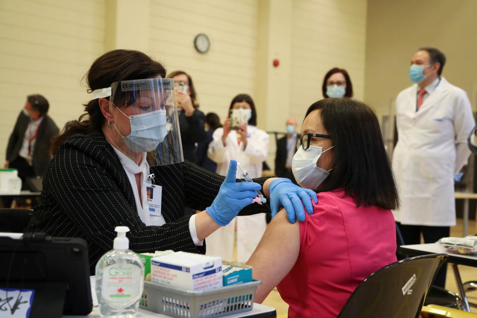 Cecile Lasco, a personal support worker, is inoculated with the Pfizer/BioNTEch coronavirus disease (COVID-19) vaccine at The Michener Institute, in Toronto, Canada December 14, 2020. REUTERS/Carlos Osorio