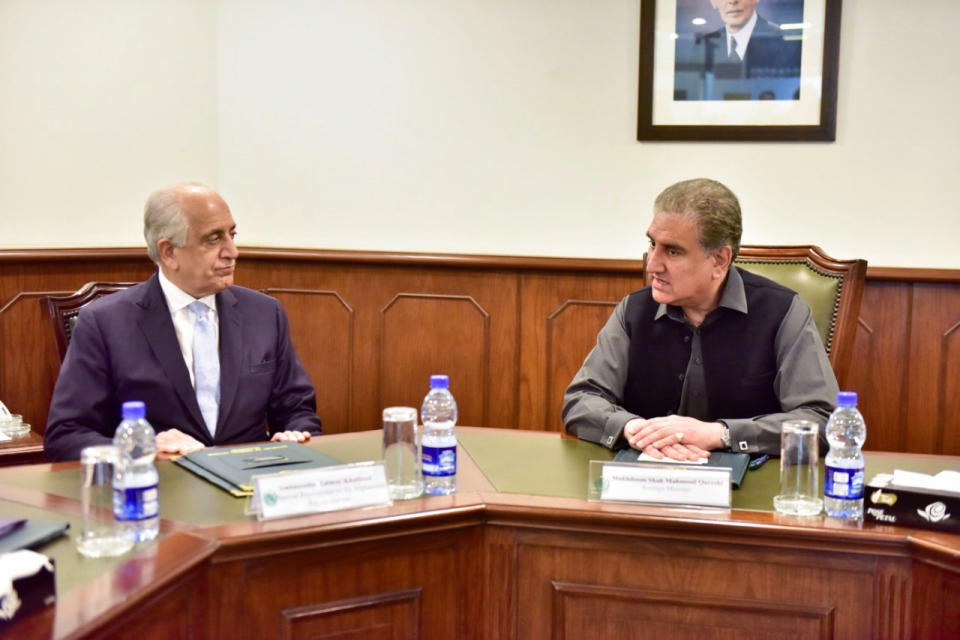 In this photo released by the Foreign Office, Pakistan's Foreign Minister Shah Mehmood Qureshi, right, meets U.S. envoy Zalmay Khalilzad at the Foreign Ministry in Islamabad, Pakistan, Friday, Jan. 31, 2020. Khalilzad has met with Pakistan's foreign minister to find a peaceful solution to neighboring Afghanistan's war. (Pakistan Foreign Office via AP)