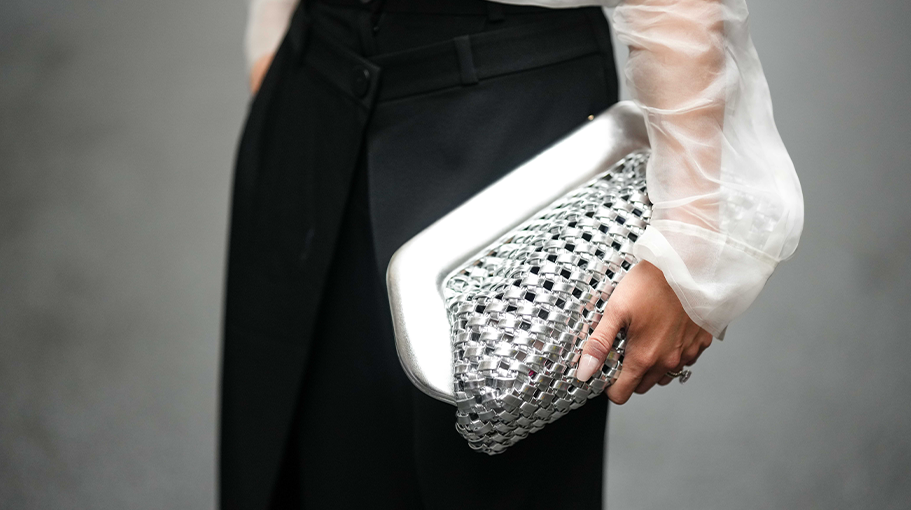 A NYFW guest carries a silver handbag in New York City.