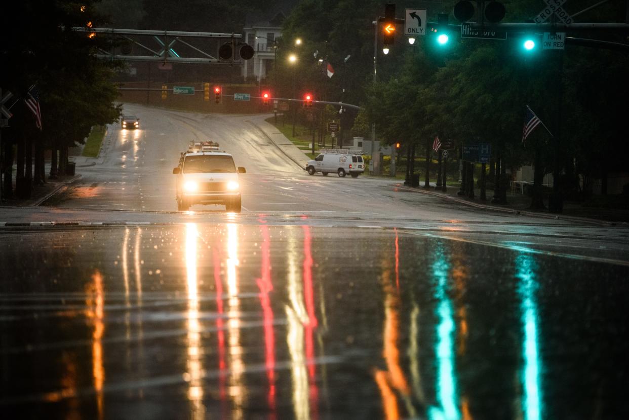 Traffic moves along Hay Street as rain from Tropical Storm Elsa falls on the region on Thursday, July 8, 2021. Inclement weather is expected Friday and Saturday as Tropical Storm Ian moves into the area.