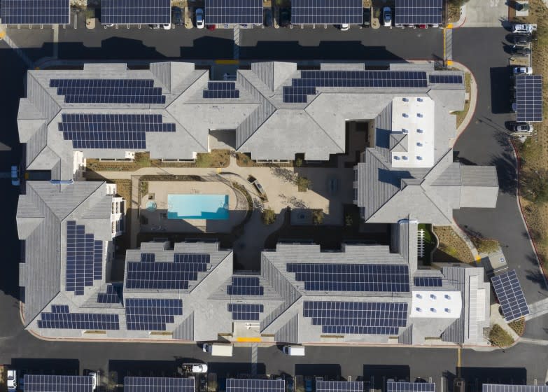 RANCHO CUCAMONGA, CA - NOVEMBER 19: An aerial view of the Dry Creek Villas energy efficient zero-net-energy senior housing development that features 600 solar panels on the roof and 500 solar panels on the carports and high efficiency natural gas boilers in Rancho Cucamonga Thursday, Nov. 19, 2020. The nonprofit affordable housing builder National CORE is building an all-electric housing development (ie. no natural gas hookups) in San Bernardino, and recently finished a zero-net-energy housing development in Rancho Cucamonga.(Allen J. Schaben / Los Angeles Times)