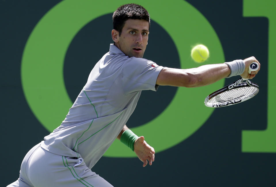 Novak Djokovic, of Serbia, returns to Tommy Robredo, of Spain, at the Sony Open Tennis tournament, Tuesday, March 25, 2014, in Key Biscayne, Fla. (AP Photo/Lynne Sladky)