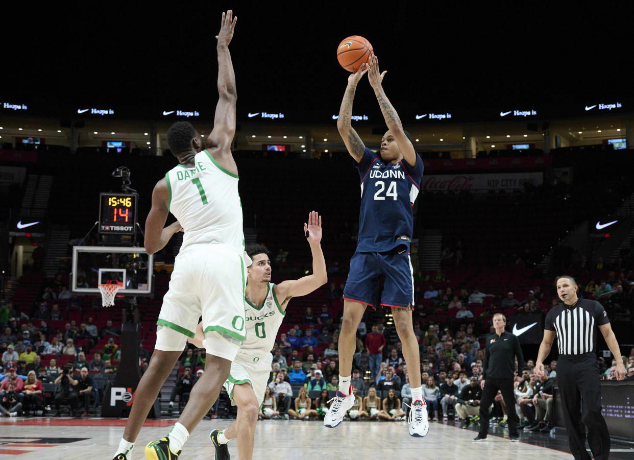 Connecticut guard Jordan Hawkins shoots against Oregon guard Will Richardson (0) and center N'Faly Dante during the Phil Knight Invitational at the Moda Center in Portland, Oregon, on Nov. 24, 2022. (Troy Wayrynen/USA TODAY Sports)
