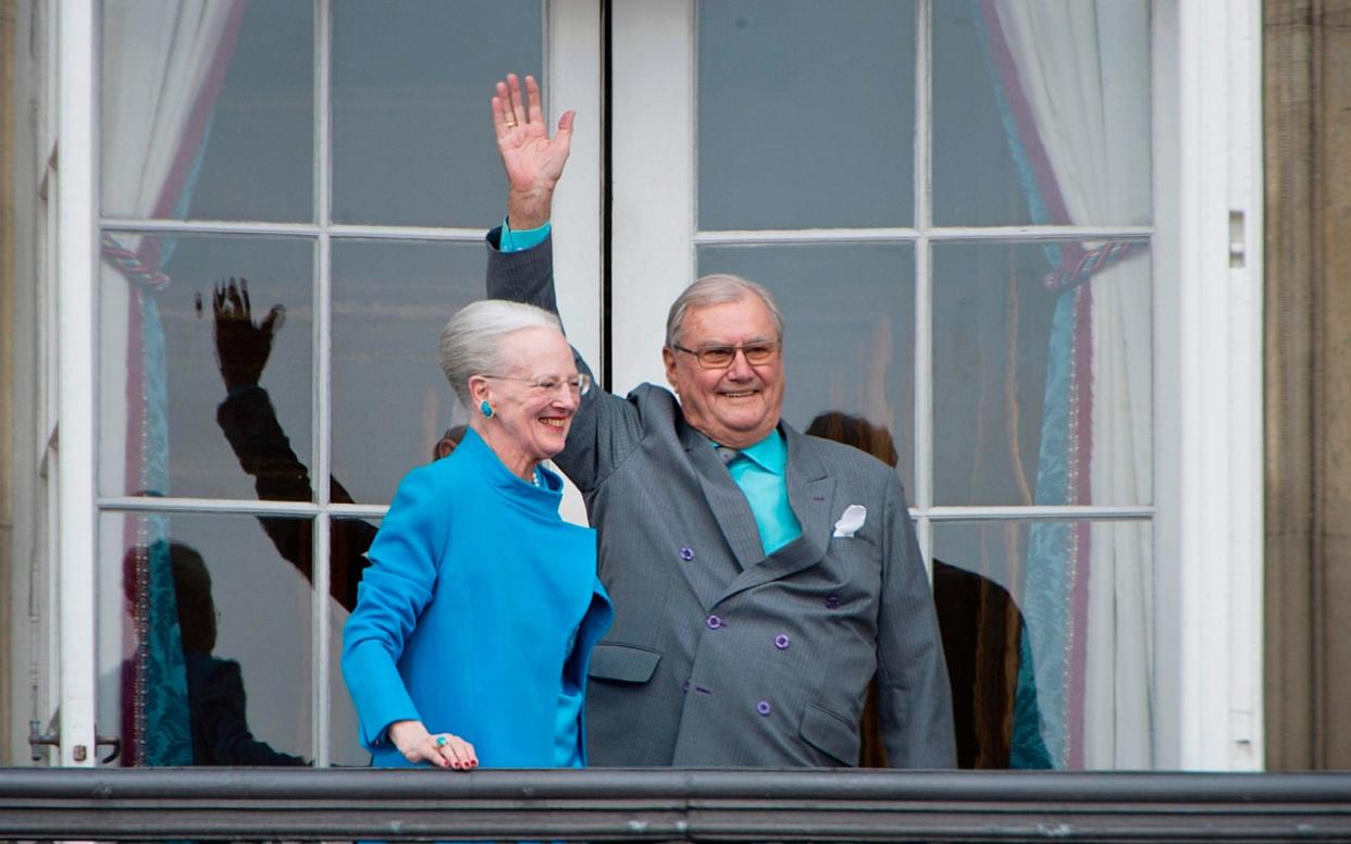 Danish Queen Margrethe and Prince Henrik greet well-wishers from the balcony at Amalienborg Palace in Copenhagen in April 2016 - AFP