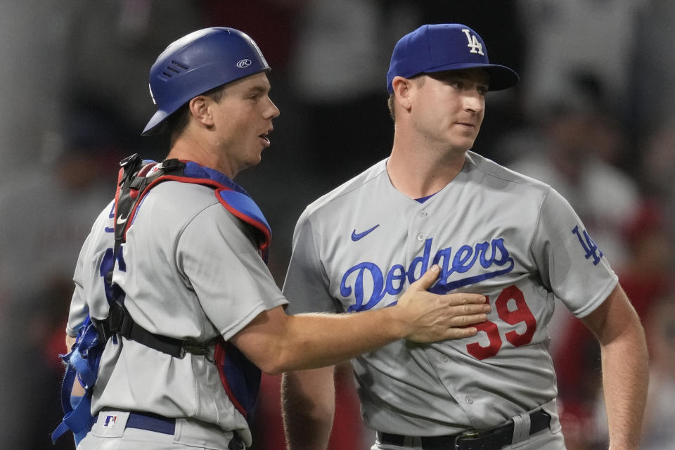 Los Angeles Dodgers catcher Will Smith (16) celebrates with relief pitcher Evan Phillips (59) after a 2-0 win over the Los Angeles Angels in a baseball game in Anaheim, Calif., Tuesday, June 20, 2023. (AP Photo/Ashley Landis)