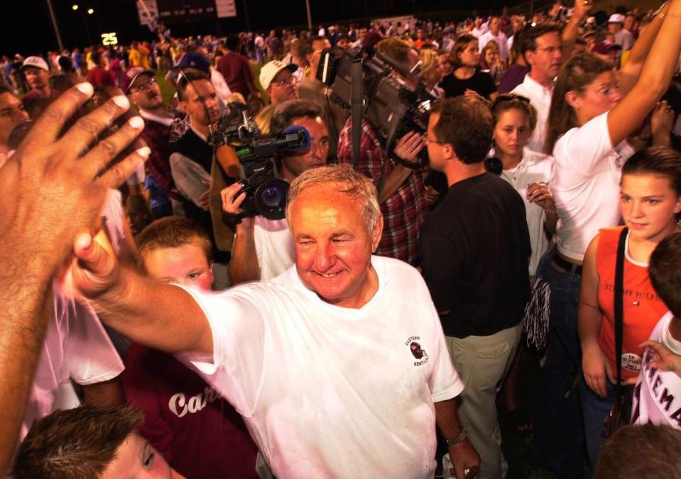 Roy Kidd gave a high-five to a fan while surrounded by well-wishers after Eastern defeated Liberty 30-7 to give the coach his 300th career victory on Sept. 8, 2001, in Richmond.