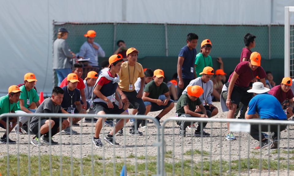 Migrant children exercise at a shelter in Homestead, Florida, on May 6, 2019.