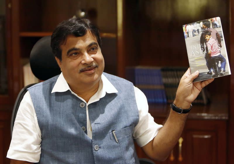 FILE PHOTO: India's Transport and Shipping Minister Gadkari displays a book written by him at his office in New Delhi