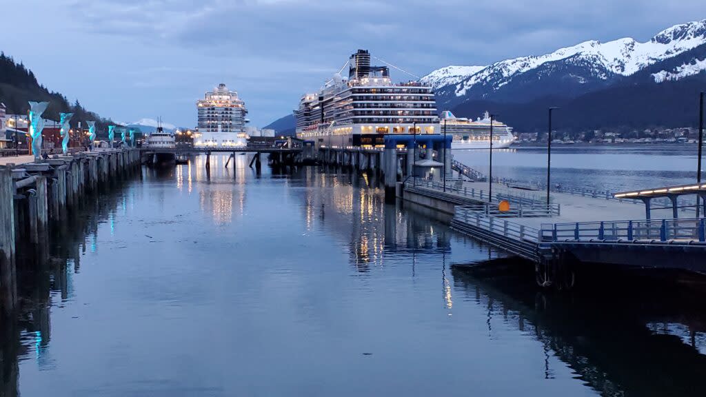 Three cruise ships are docked along Juneau's waterfront on the evening on March 10, as a Princess cruise ship on the right is departing the capital city. (Photo by Yereth Rosen/Alaska Beacon)