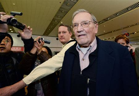 Veteran U.S. soldier Merrill Newman (C), who was detained for over a month in North Korea, arrives at Beijing airport in Beijing, in this photo taken by Kyodo December 7, 2013. Mandatory credit REUTERS/Kyodo