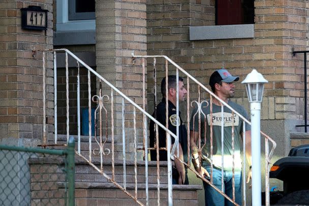 PHOTO: A New Jersey police officer and a plain-clothed police officer exit the building where alleged attacker of Salman Rushdie, Hadi Matar, lives in Fairview, N.J.,  Aug. 12, 2022. (Eduardo Munoz/Reuters)