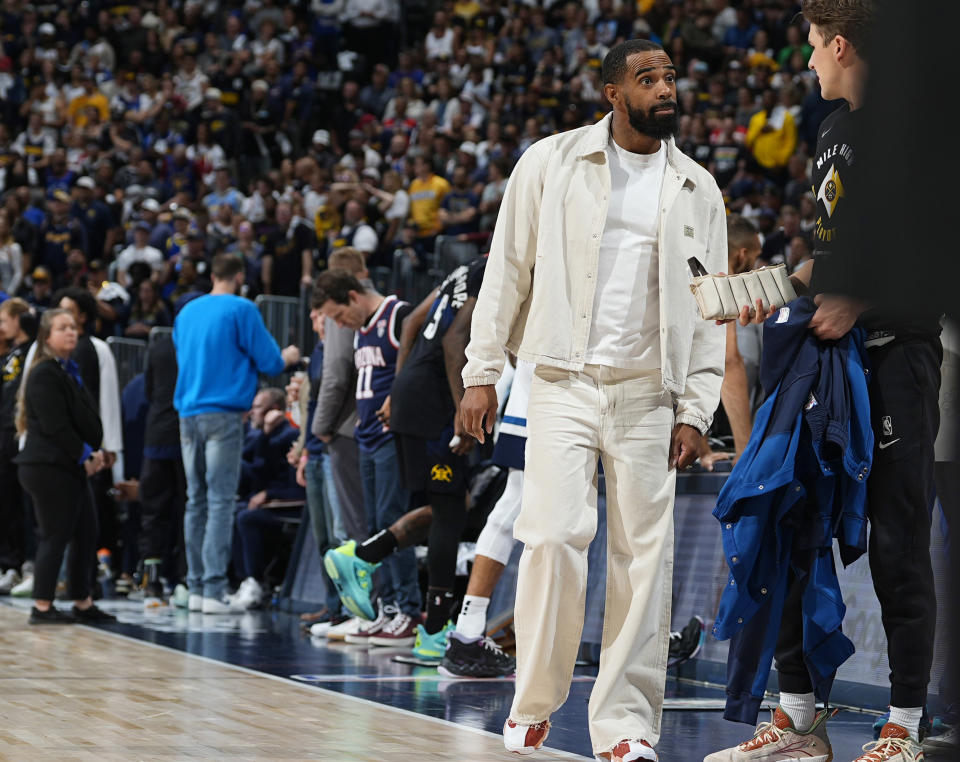 Injured Minnesota Timberwolves guard Mike Conley walks near the bench during the first half of Game 5 of the team's NBA basketball second-round playoff series against the Denver Nuggets on Tuesday, May 14, 2024, in Denver (AP Photo/David Zalubowski)