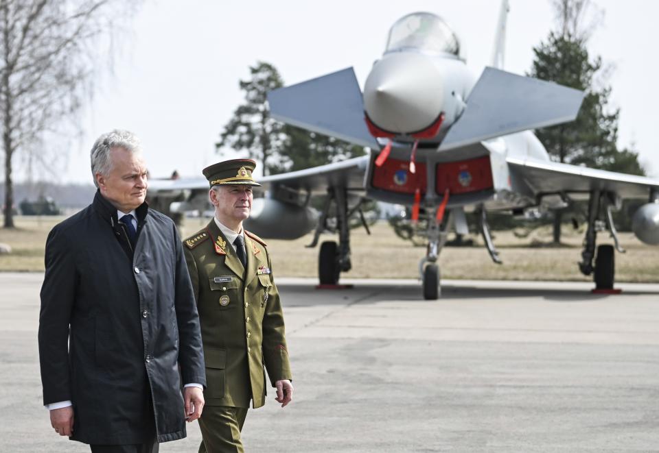 In this photo provided by Lithuanian Ministry of National Defense, Lithuania's Presiodent Gitanas Nauseda , left, and Chief of Defence of Lithuania Gen Valdemaras Rupsys arrive for celebration Lithuania's NATO membership 20th anniversary at the Siauliai airbase, some 230 km (144 miles) east of the capital Vilnius, Lithuania, Thursday, March 28, 2024. (Alfredas Pliadis/Lithuanian Ministry of National Defense via AP)