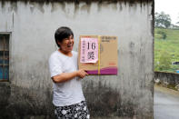 Chen Hong-zhi, 26, who suffers from short-term memory loss, poses with an electric fan he won in a lottery, in Hsinchu, Taiwan, September 26, 2018. REUTERS/Tyrone Siu