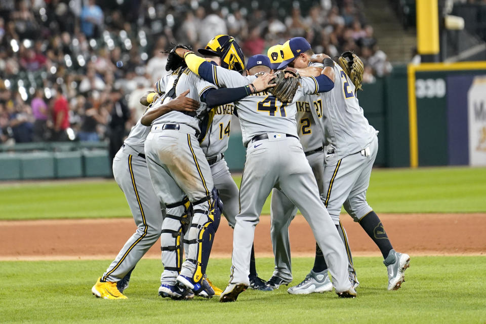 The Milwaukee Brewers celebrate the team's 7-6 win over the Chicago White Sox in a baseball game Friday, Aug. 11, 2023, in Chicago. (AP Photo/Charles Rex Arbogast)