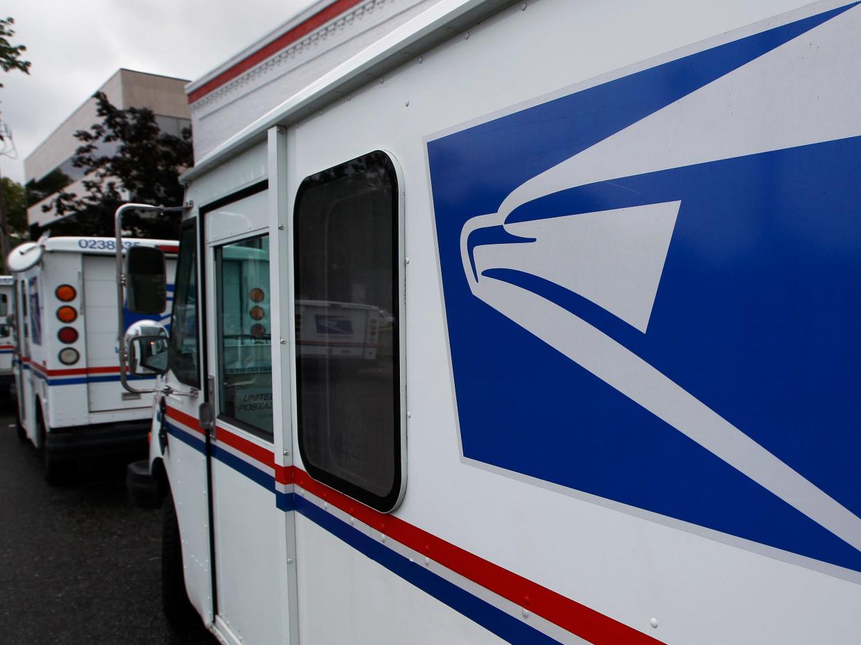 A white truck bearing the USPS logo.