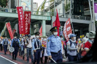 <p>Protesters against the Tokyo 2020 Olympics are seen from a taxi as they march in Tokyo, Japan, Friday, July 23, 2021, (AP Photo/Carolyn Kaster)</p> 