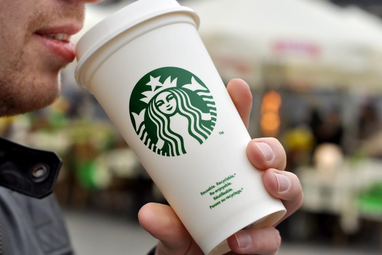 unidentified man drinking starbucks