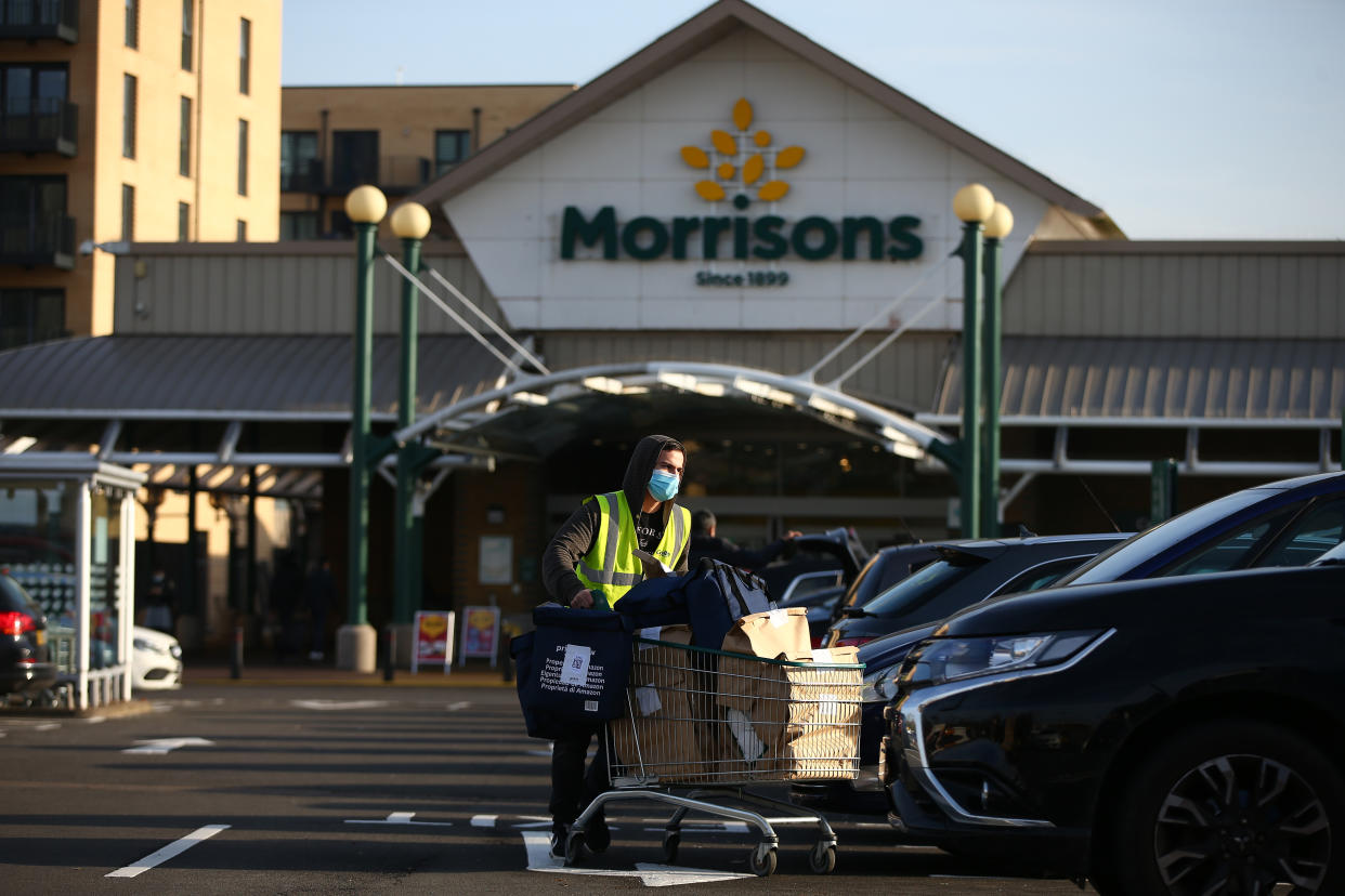 LONDON, ENGLAND - NOVEMBER 07: A delivery driver loads groceries into his car outside a Morrisons in Edgware on November 7, 2020 in London, England. The country has gone into it's second national lockdown since the Coronavirus (COVID-19) pandemic began. (Photo by Hollie Adams/Getty Images)