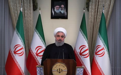 President Hassan Rouhani addresses the nation in a televised speech in Tehran, Iran - Credit: AP