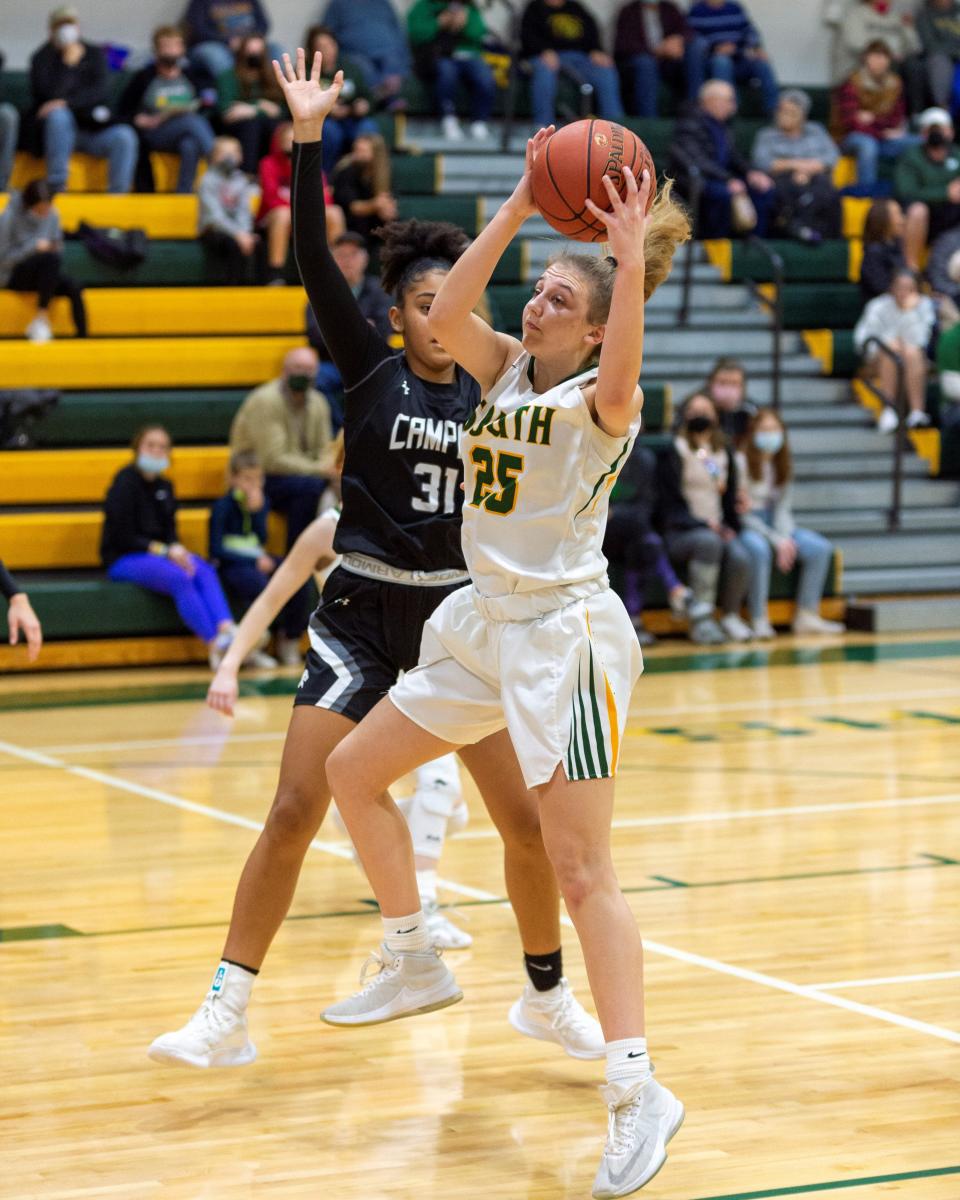 Salina South's Lauren Harris (25) pulls down a rebound  Friday night against Campus at the South gym. Harris had 12 points and 10 rebounds in the Cougars 59-20 victory.