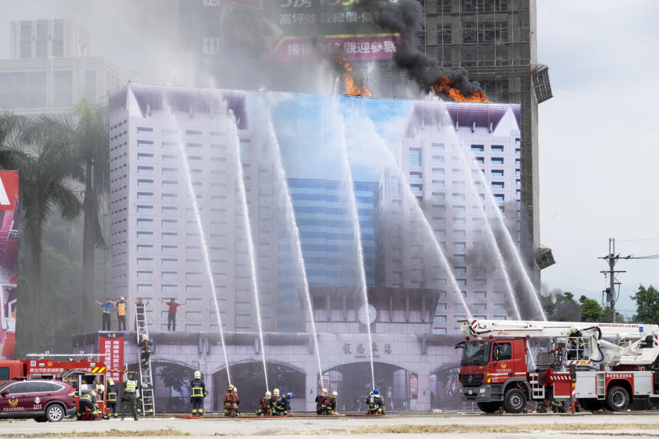 Firefighters put out fire during drills simulating Chinese missile attacks in New Taipei City, Taiwan on July 14, 2022. While an invasion doesn’t appear imminent, China's recent large-scale military exercises in response to a visit by U.S. House Speaker Nancy Pelosi to Taiwan have made the government in Taipei more aware than ever of the hard power behind Beijing’s rhetoric about bringing the self-ruled island under its control. Experts said that civilian defense and reserve forces have an important deterrent effect, showing a potential aggressor that the risks of invasion are high. (AP Photo/Huizhong Wu)