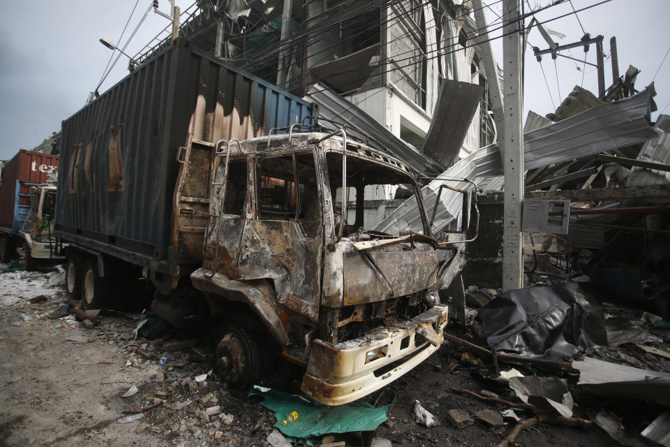 A charred truck sits in the wreckage after and explosion and raging fire at a chemical factory in Samut Prakan province, Thailand, Monday, July 5, 2021. A massive explosion at a factory on the outskirts of Bangkok has damaged homes in the surrounding neighborhoods and prompted the evacuation of a wide area over fears of poisonous fumes from burning chemicals and the possibility of additional denotations. At least one person has been killed and dozens have been injured. (AP Photo)