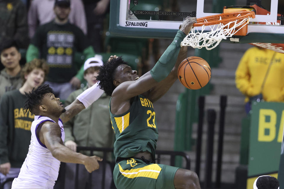 Baylor forward Jonathan Tchamwa Tchatchoua (23) dunks over Alcorn State guard Paul King in the second half of an NCAA college basketball game, Monday, Dec. 20, 2021, in Waco, Texas. (AP Photo/Rod Aydelotte)