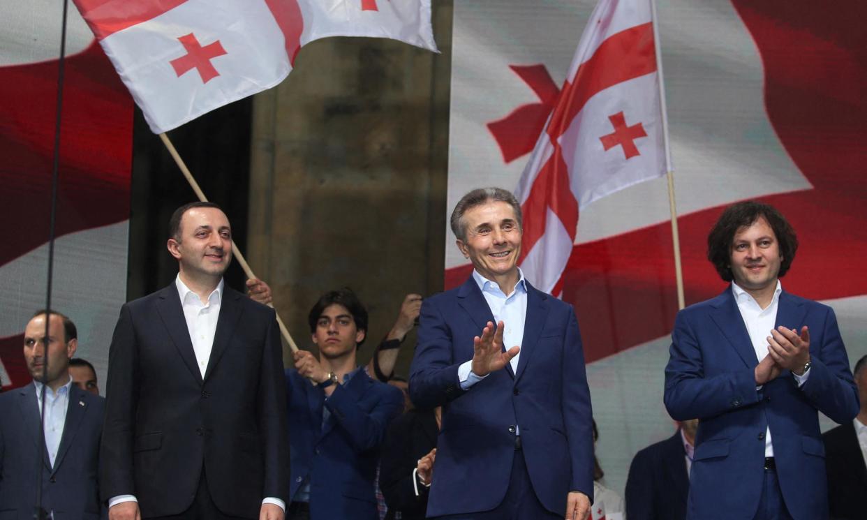 <span>Bidzina Ivanishvili (centre) flanked by the chair of his Georgian Dream party and former prime minister, Irakli Garibashvili (left), and the current PM, Irakli Kobakhidze, at a rally for their ‘foreign agents’ law in April.</span><span>Photograph: Irakli Gedenidze/Reuters</span>