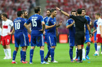 WARSAW, POLAND - JUNE 08: The Greek players appeal to the Referee Carlos Velasco Carballo as Sokratis Papastathopoulos of Greece (R) is shown a second yellow card and sent off during the UEFA EURO 2012 group A match between Poland and Greece at The National Stadium on June 8, 2012 in Warsaw, Poland. (Photo by Michael Steele/Getty Images)